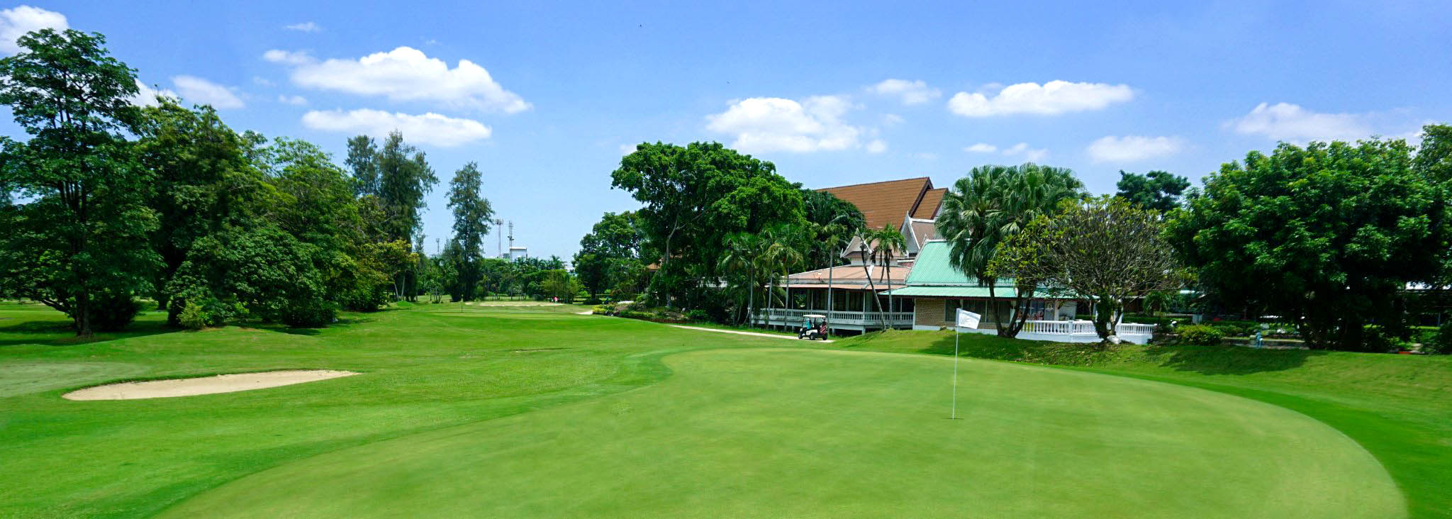 Ekachai Golf and Country Club clubhouse view blue sky green